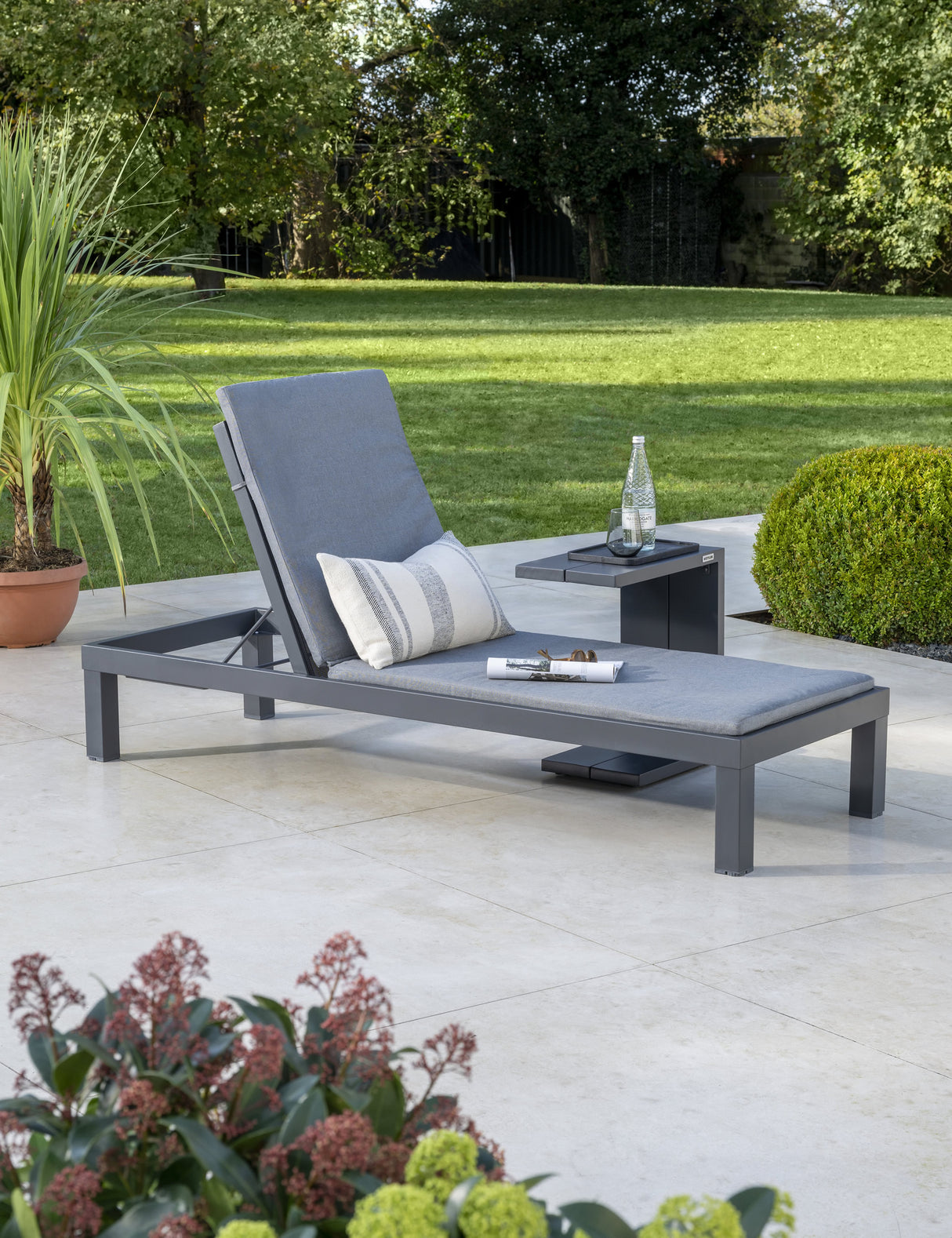Kettler Elba grey metal side table next to outdoor lounger, modern furniture for patio or garden.