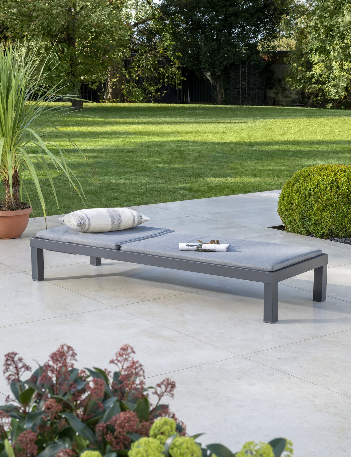 Kettler Elba Signature sun lounger in grey with cushion, metal outdoor furniture in a relaxed outdoor setting