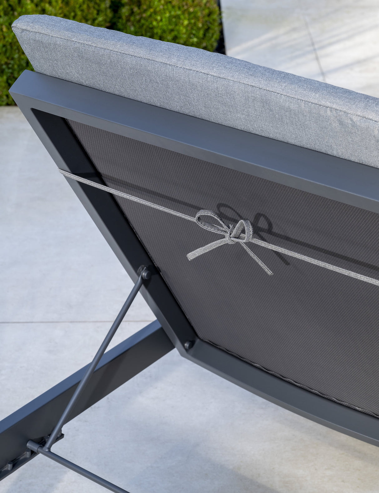 Kettler Elba Signature Sun Lounger in grey with cushion, showing rear fastening detail on metal outdoor furniture.