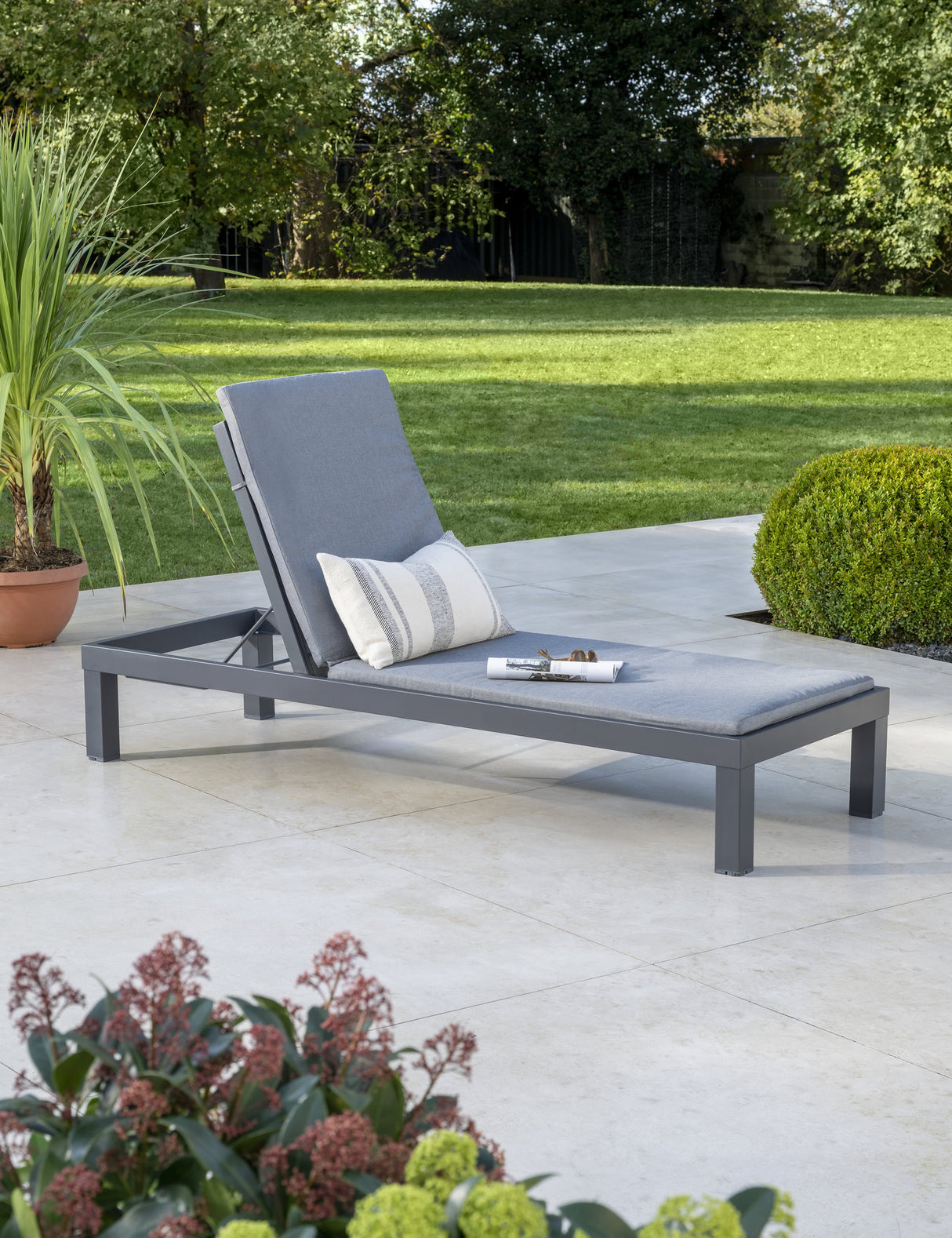 Kettler Elba Signature grey sun lounger in upright position with cushion, outdoor metal furniture for relaxing in the garden.