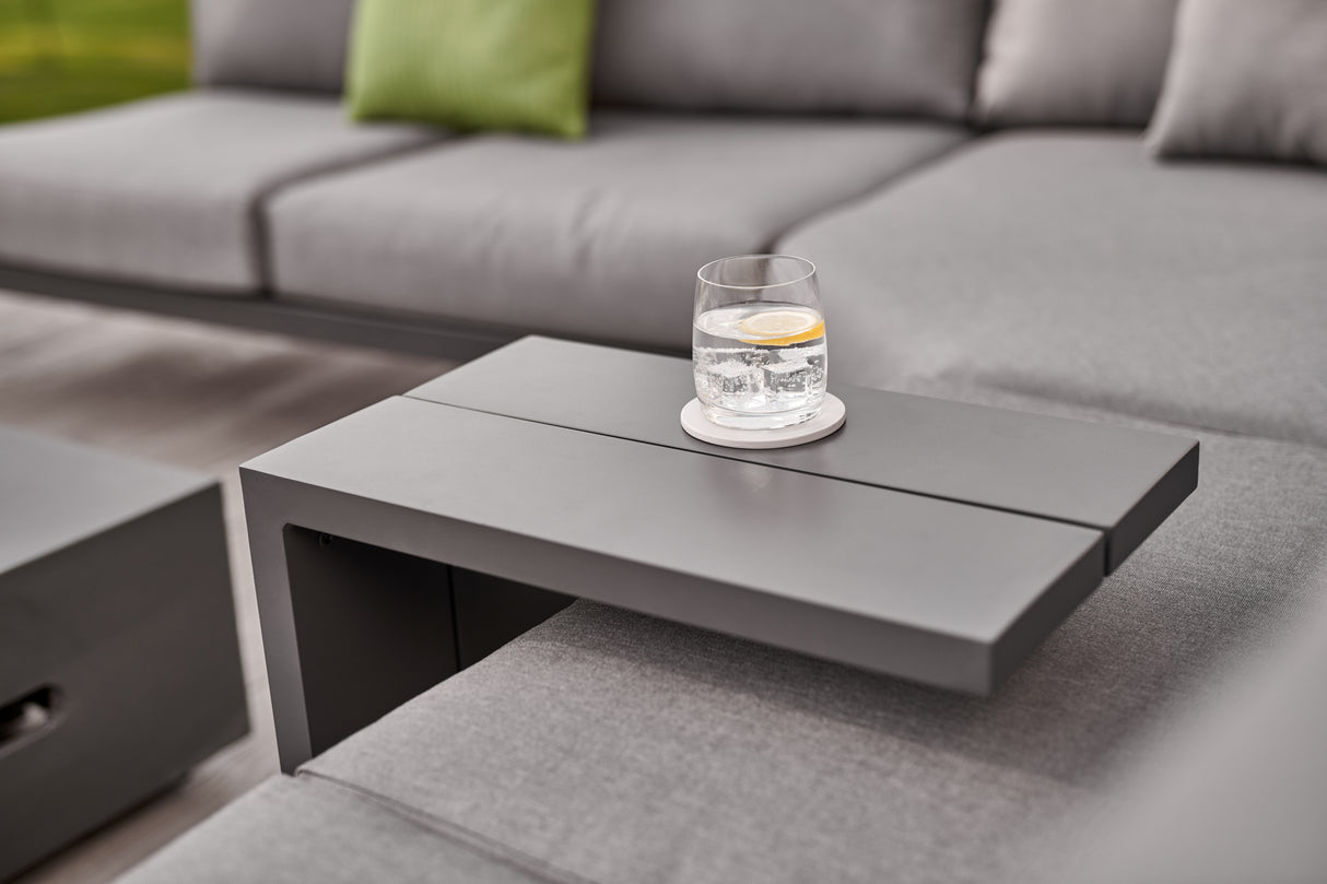 Kettler Elba grey metal side table in a modern lounge setting, showcasing its sleek design and compact size.
