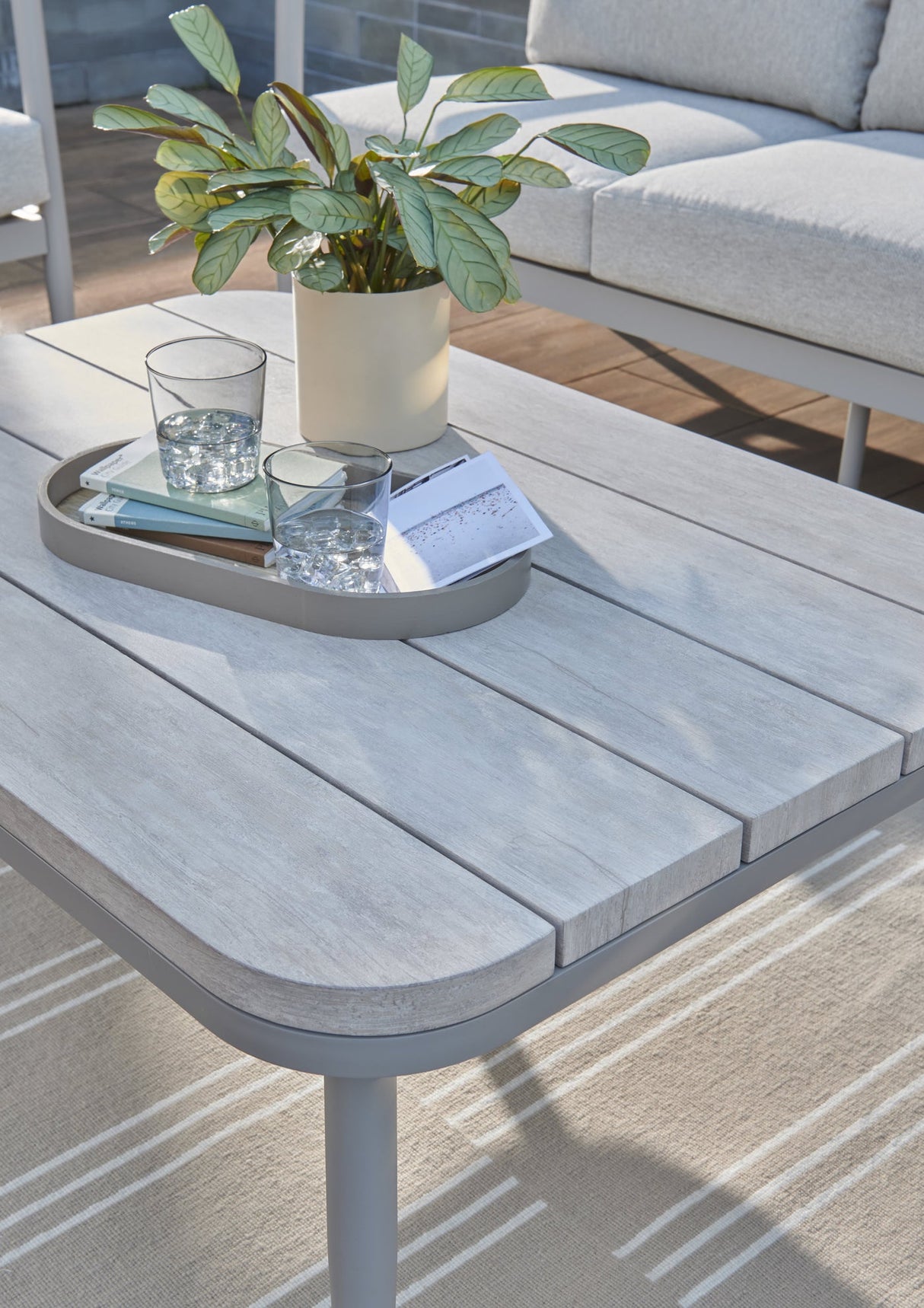Close-up of the Kettler Trento 5-seat rope lounge set coffee table top showing woven metal design and stylish outdoor furniture.