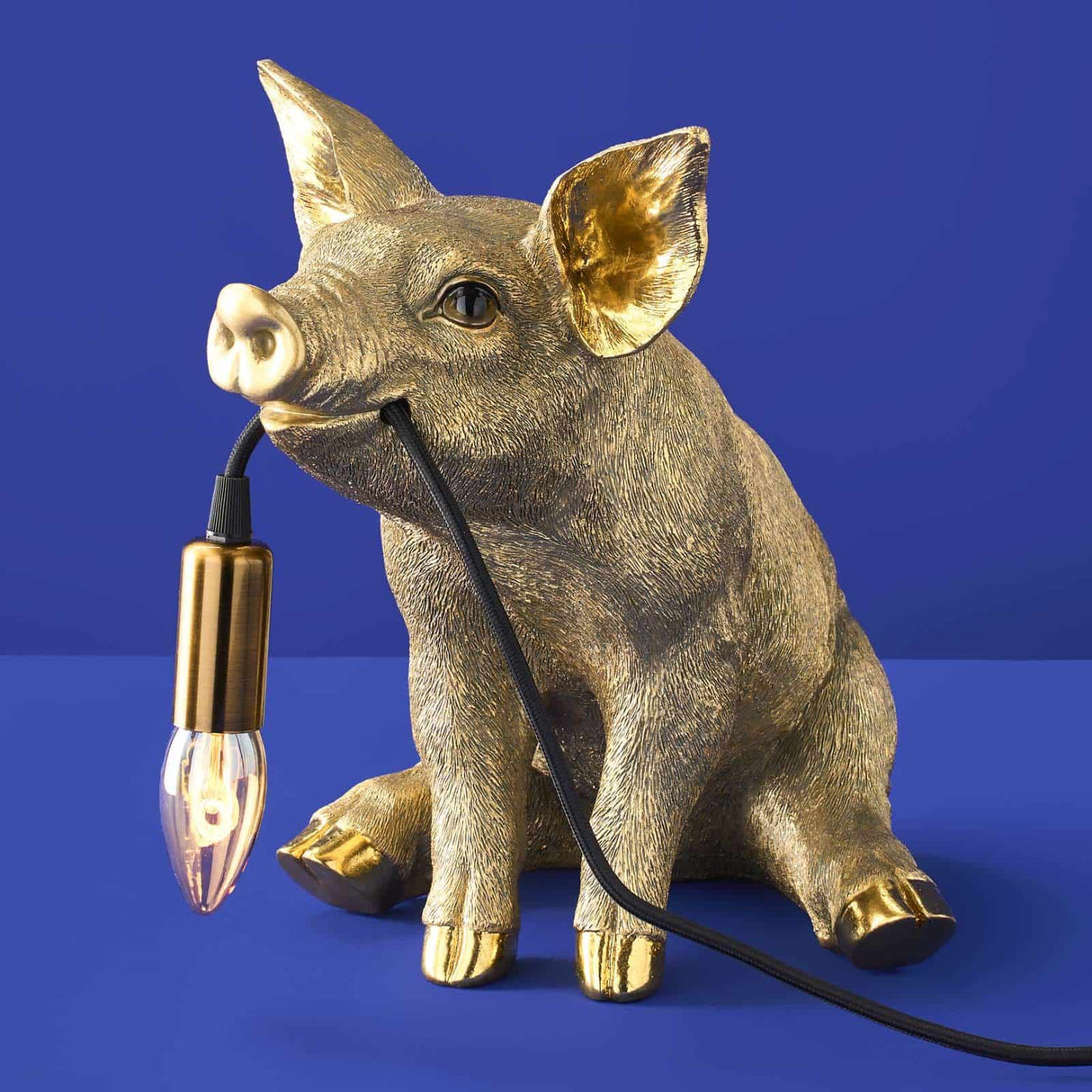 Gold Werner Vob WERNS® Piggy Pig table lamp with a stylish pig design, perfect for luxury indoor statement lighting.