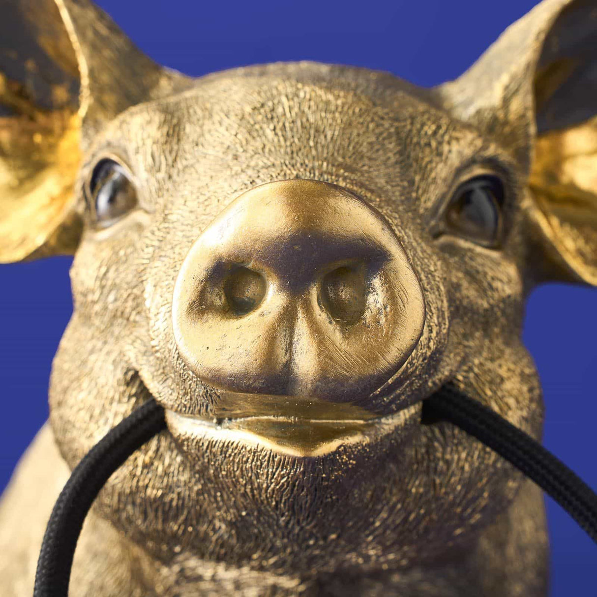 Gold WERNS® Piggy Pig table lamp by Werner Vob, a luxury designer pig-shaped indoor lighting piece with a stylish modern look.