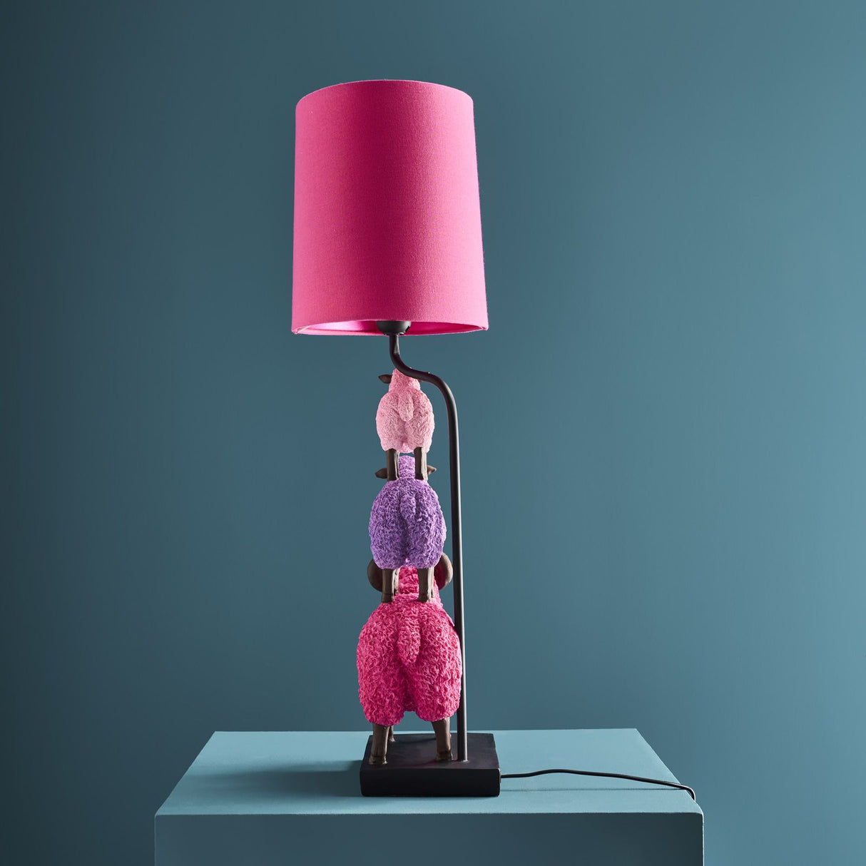 Colorful pink WERNS® sheep table lamp by Werner Vob, featuring a playful luxury designer sheep shape for statement indoor lighting.