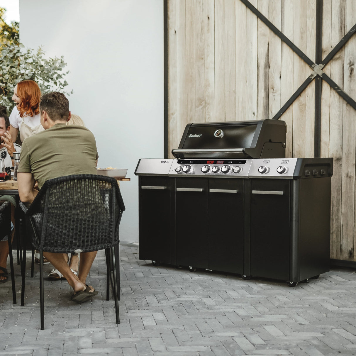 Enders UNIQ PRO 3 IK Turbo Gas BBQ with cover, stainless steel grill, side shelves, and control knobs for outdoor cooking.