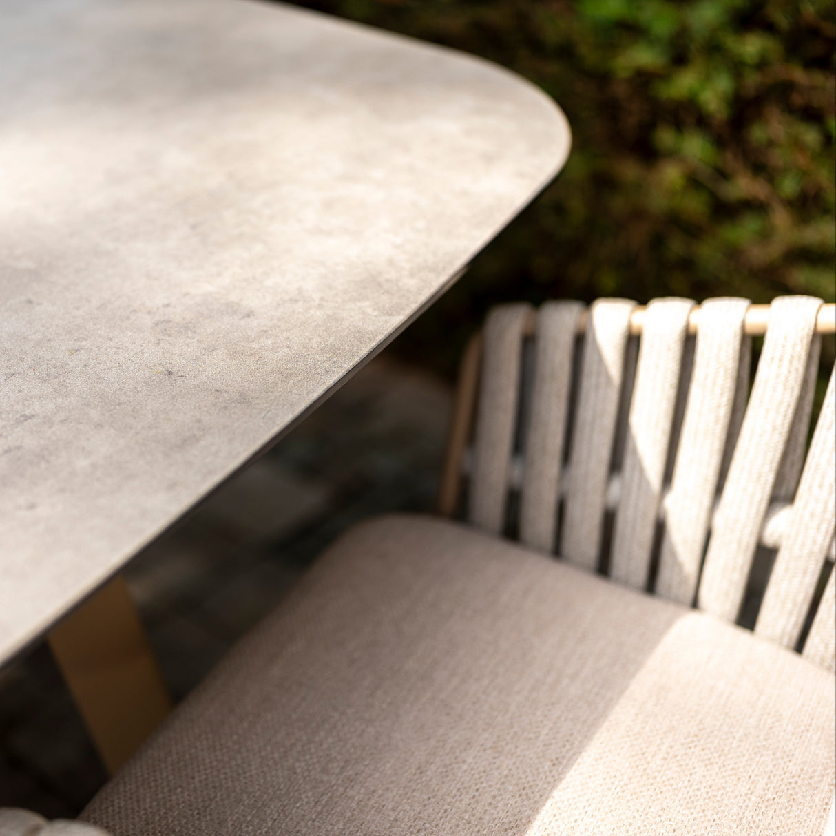 4 Seasons Outdoor Eva 6-seat metal dining set with Manolo 180cm barrel ceramic table and matching dining chairs.