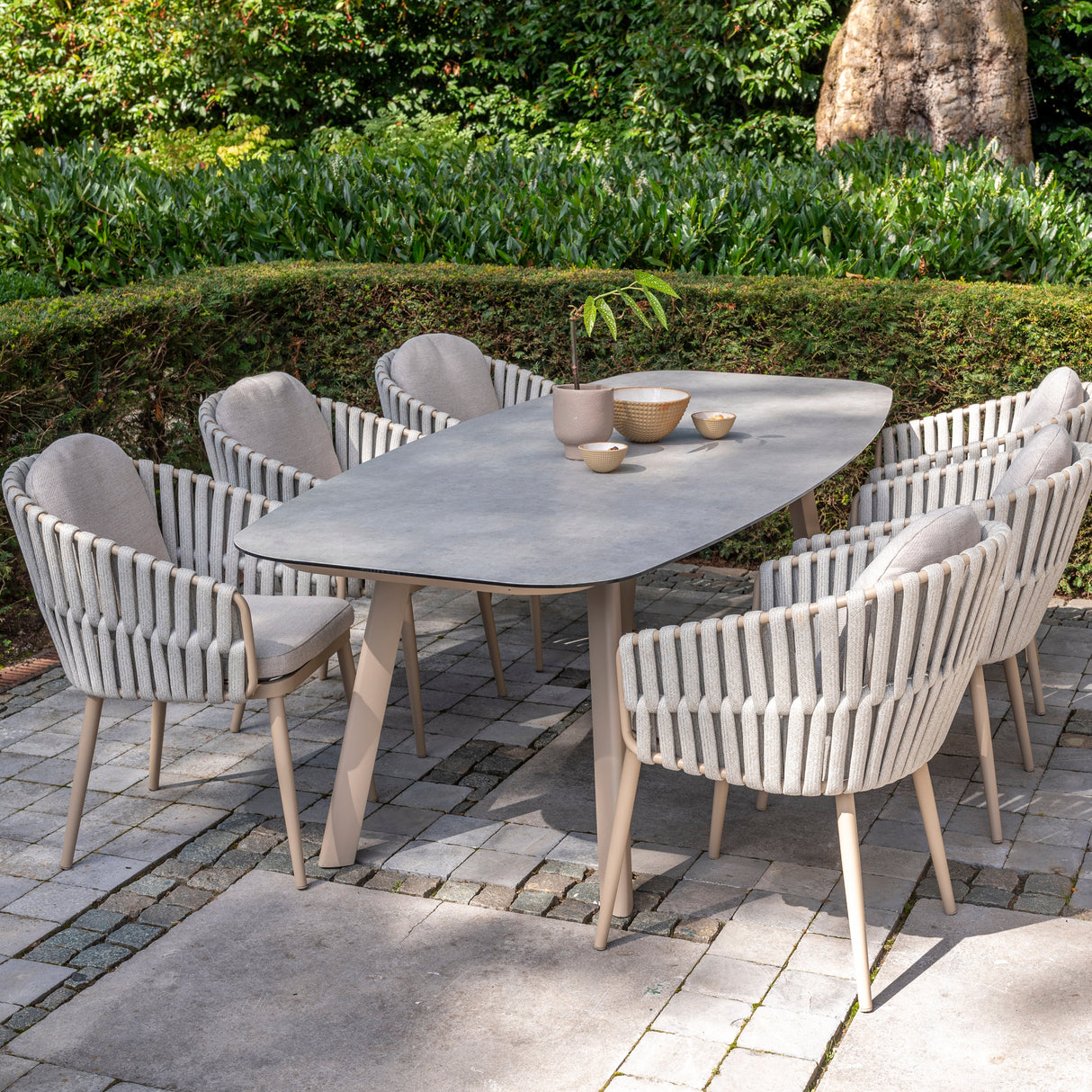4 Seasons Outdoor Eva 6-seat dining set with Manolo 180cm barrel ceramic table and metal chairs in latte finish.