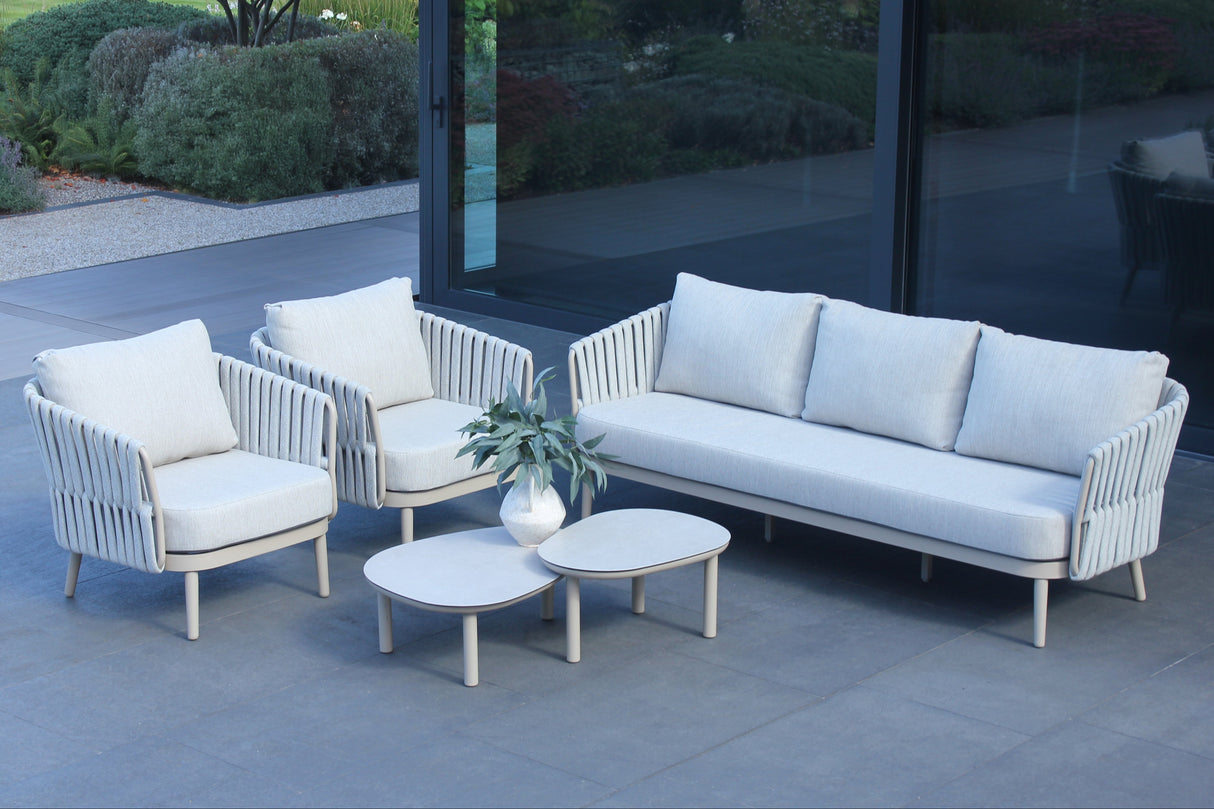 4 Seasons Outdoor Eva lounge set with two Monroe coffee tables and a gentle support table, featuring metal frame and plush cushions.