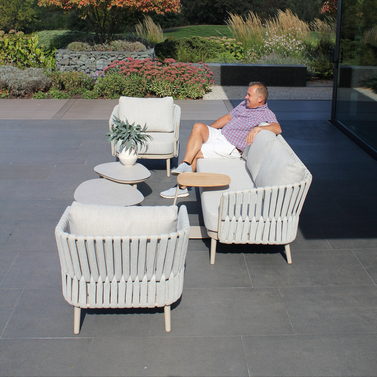 4 Seasons Outdoor Eva lounge set with metal frames, including 2 Monroe coffee tables and a gentle support table, in a latte finish.