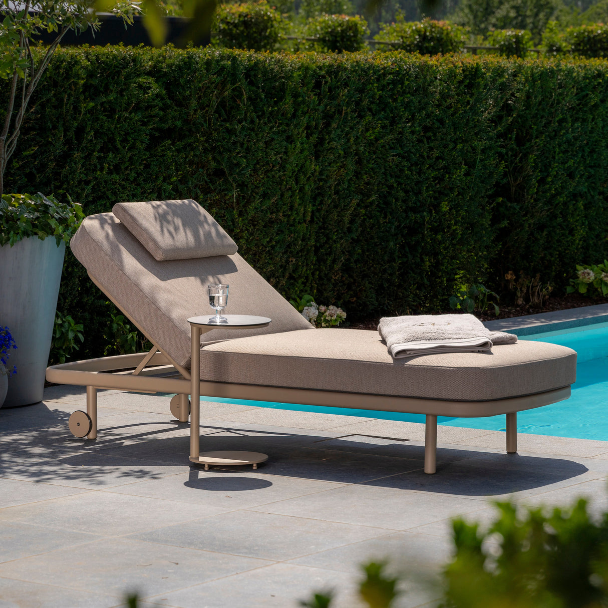 4 Seasons Outdoor Milano sunbed in Latte with cushion and headrest, metal garden furniture for outdoor lounging.