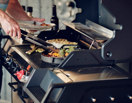 Enders Monroe Pro 4 SIK Turbo BBQ grill with cover, featuring stainless steel construction and multiple burners for outdoor cooking.