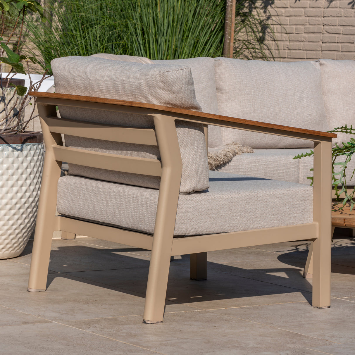 4 Seasons Outdoor Olivia lounge set with metal coffee table and footstool, featuring cushioned seating and stylish outdoor furniture.