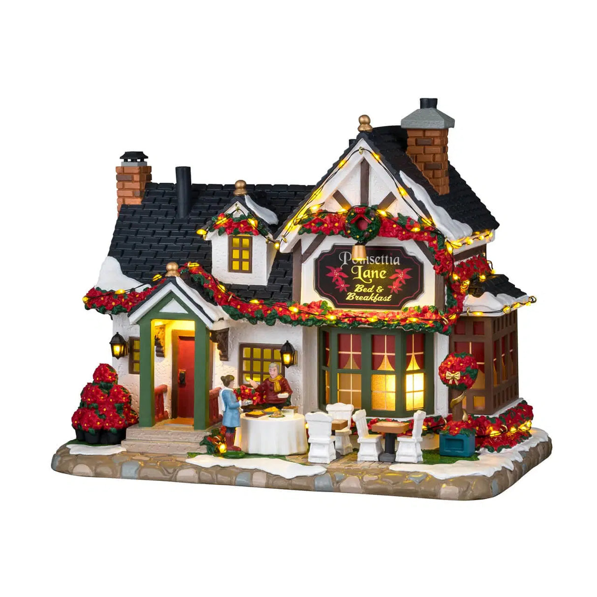 Lemax Poinsettia Lane Bed & Breakfast illuminated building from Christmas village collection, featuring festive holiday lighting.