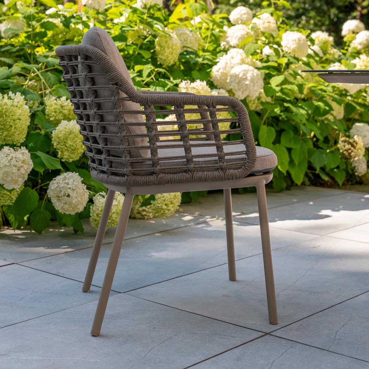 4 Seasons Outdoor Puglia 6-seat round metal dining set with Donato Latte table, featuring elegant outdoor furniture design