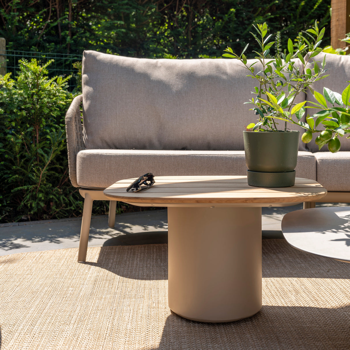 4 Seasons Outdoor Puglia Lounge LUX set in latte with 3-seater sofa, chairs, footstool, and tables in outdoor setting.