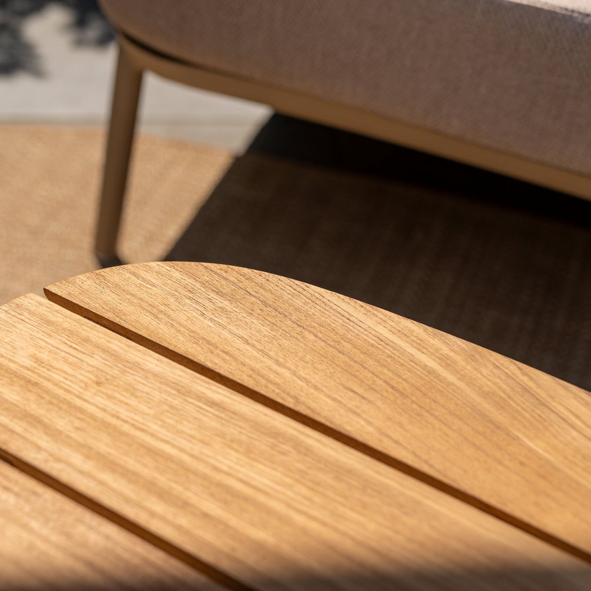 4 Seasons Outdoor Puglia Lounge LUX set in Latte with a 3-seater sofa, chairs, footstool, and tables in a garden setting.