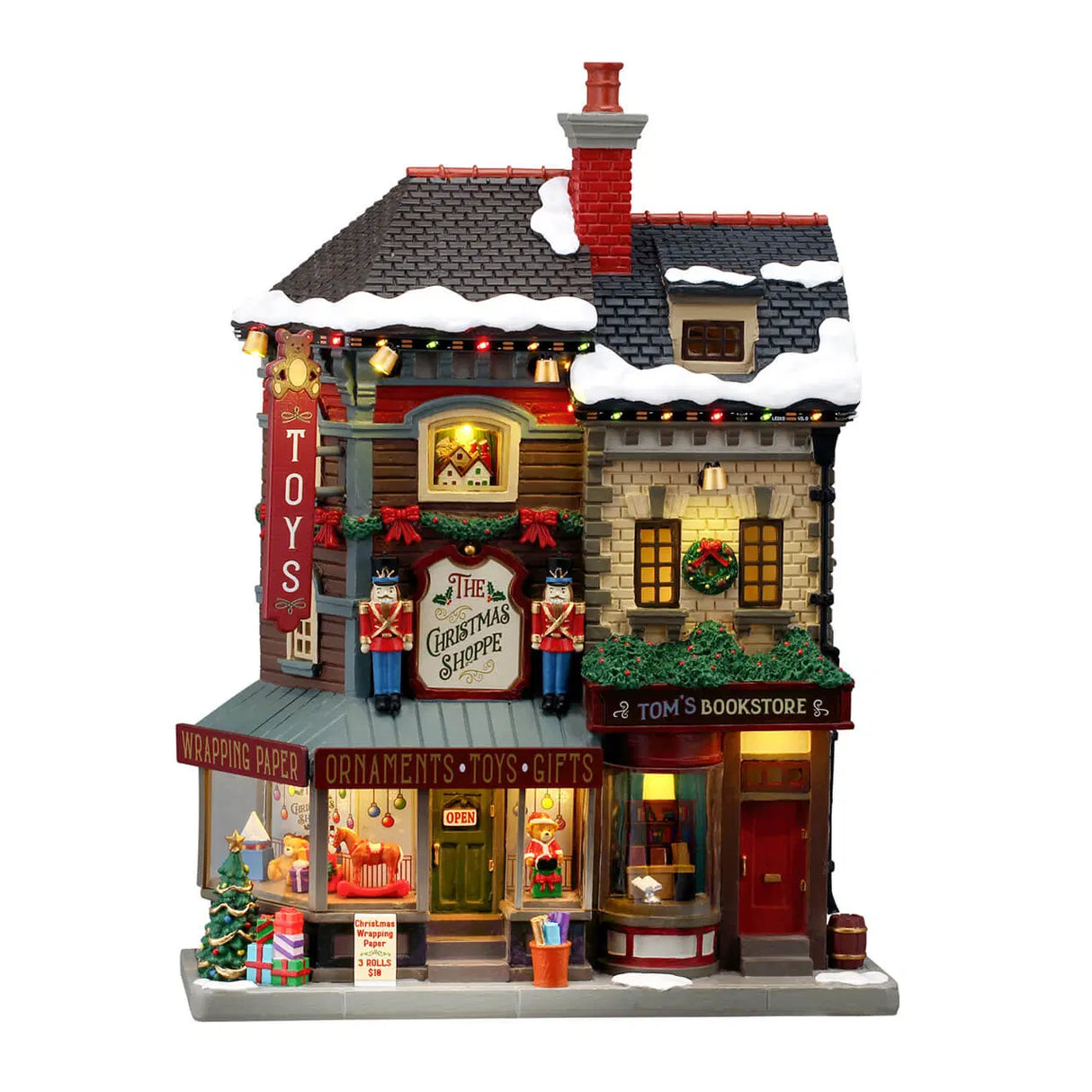 Lemax Christmas Village illuminated facade featuring The Christmas Shoppe with festive holiday details and lights.