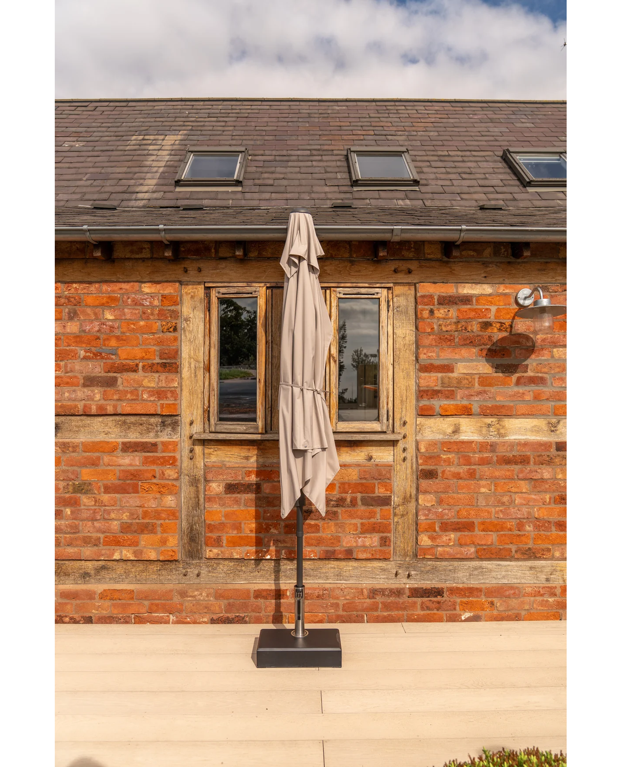 Kettler rectangular balcony parasol with auto tilt and night cover, wall-mounted outdoor furniture shade with wind-up feature.