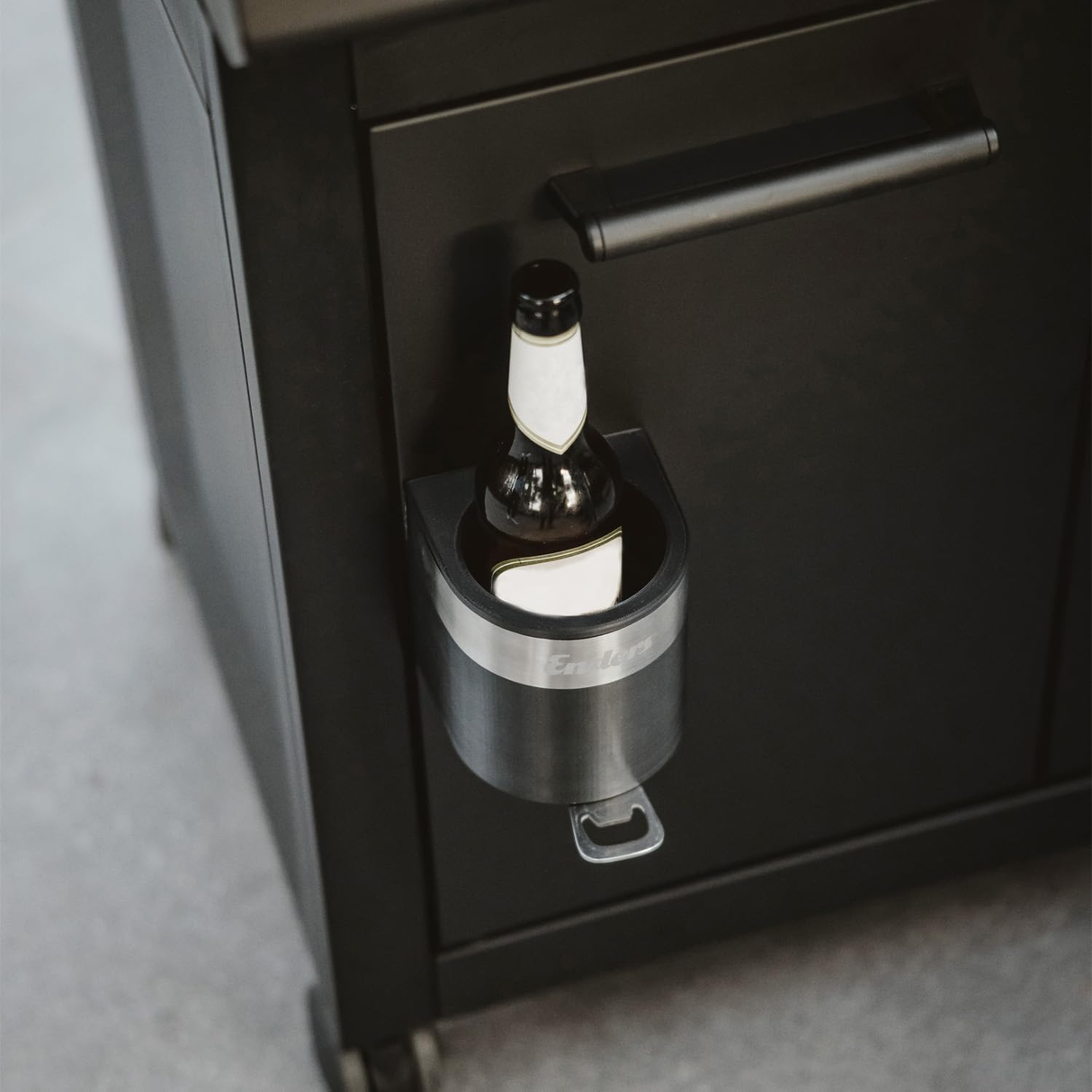 Enders Grill Mags Bottle Holder attached to a barbecue grill, designed to hold bottles securely during grilling.