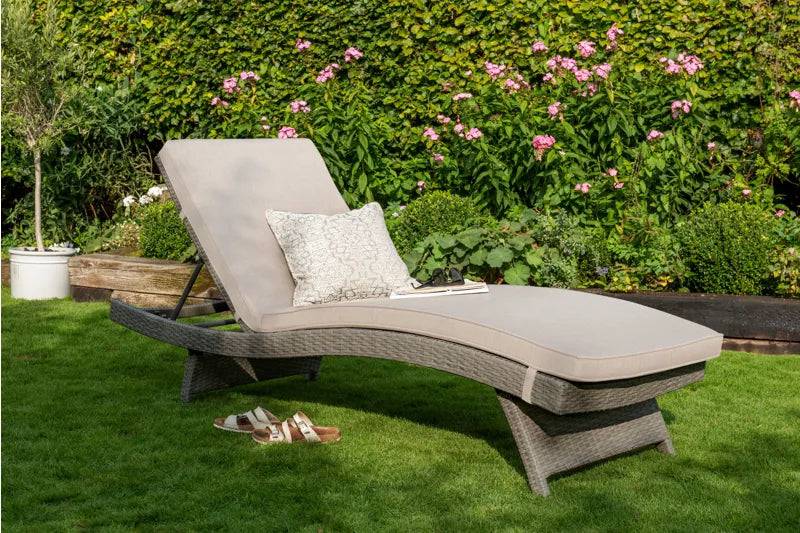Kettler Charlbury Signature sun lounger with woven frame and natural cushions, outdoor furniture for relaxing leisure spaces.