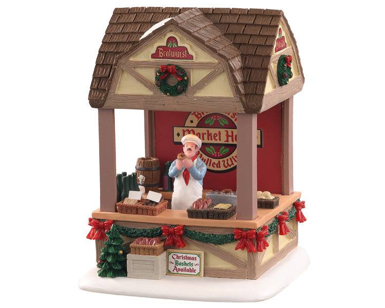 Lemax Christmas Village table accent featuring a Christmas market scene with bratwurst stand and festive holiday decorations.