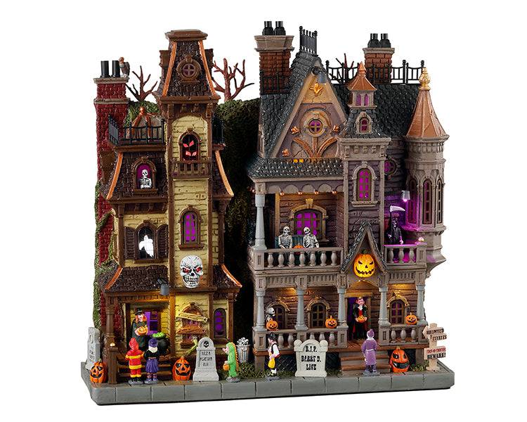 Lemax Spooky Town Haunted Estates illuminated facade with spooky haunted house details and glowing windows.