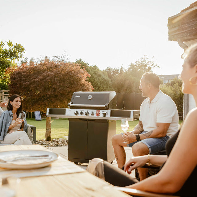 Enders Uniq 3 IK Cruster gas BBQ with stainless steel grates and integrated side shelves in outdoor setting.