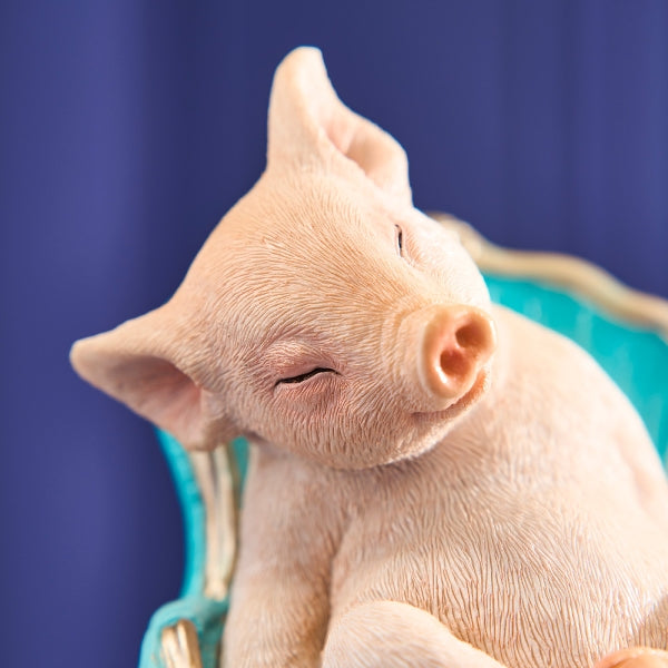 Werner Voß snoozing piglet ornament sitting on an armchair, detailed ceramic figurine, 20cm, luxurious German designer home decor.