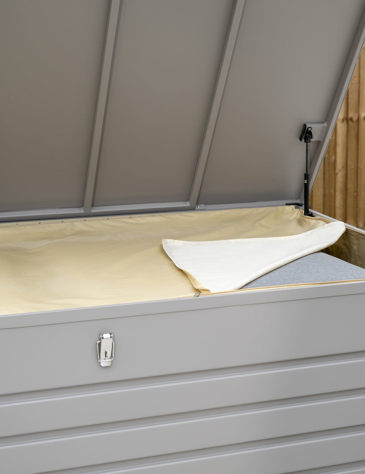 Open Kettler Pebble aluminium storage cushion box showing interior space and sleek metallic finish for outdoor furniture storage.