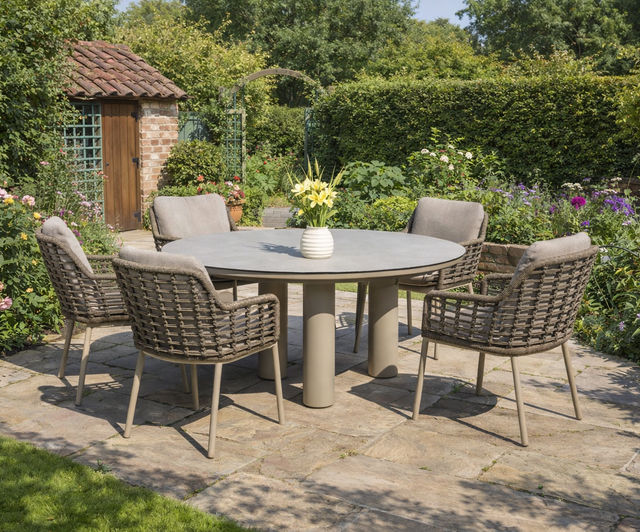 4 Seasons Outdoor Puglia 6-seat round dining set with Donato latte table, featuring metal construction and modern outdoor furniture design.
