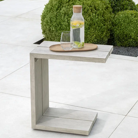 Kettler Pebble Drift side table with metal frame and textured pebble finish, suitable for indoor or outdoor living spaces.