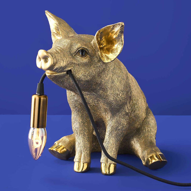 Gold Werner Vob WERNS® Piggy Pig table lamp with a stylish pig design, perfect for luxury indoor statement lighting.