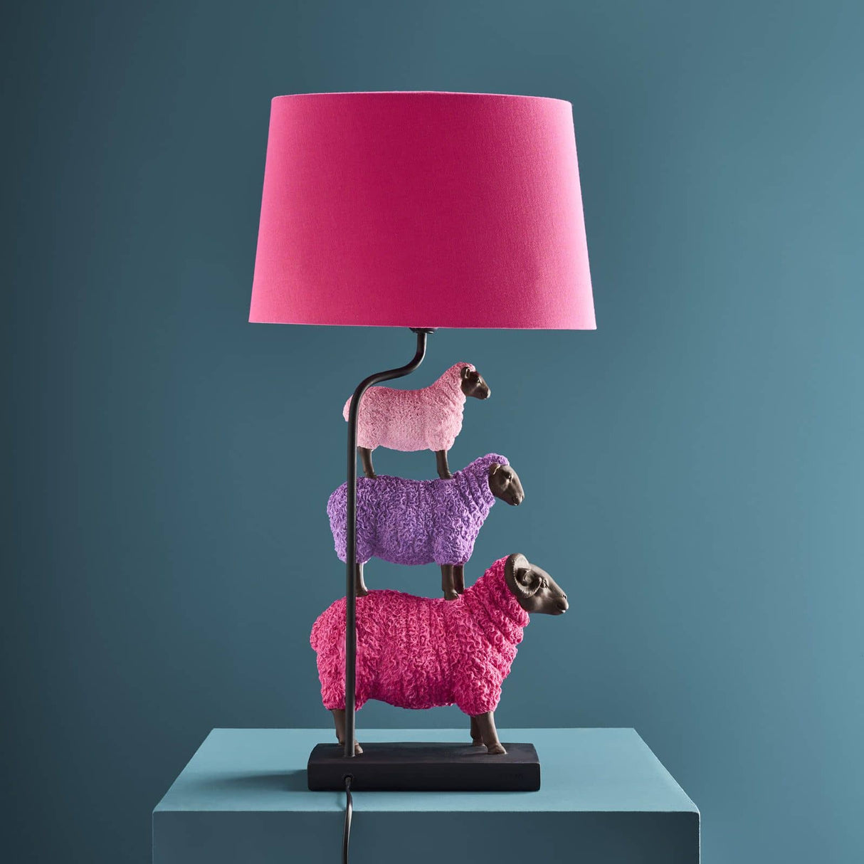 Colorful pink WERNS® sheep table lamp by Werner Vob, luxury designer indoor lighting with playful sheep shape, decorative statement piece.