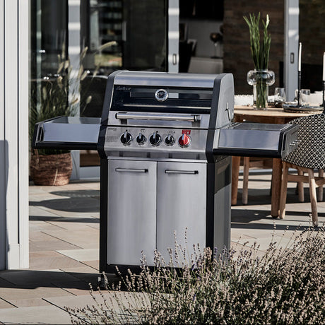 Enders Monroe Pro 3 SIK Turbo BBQ with free cover, stainless steel grill, multiple burners, and side shelves for outdoor cooking.
