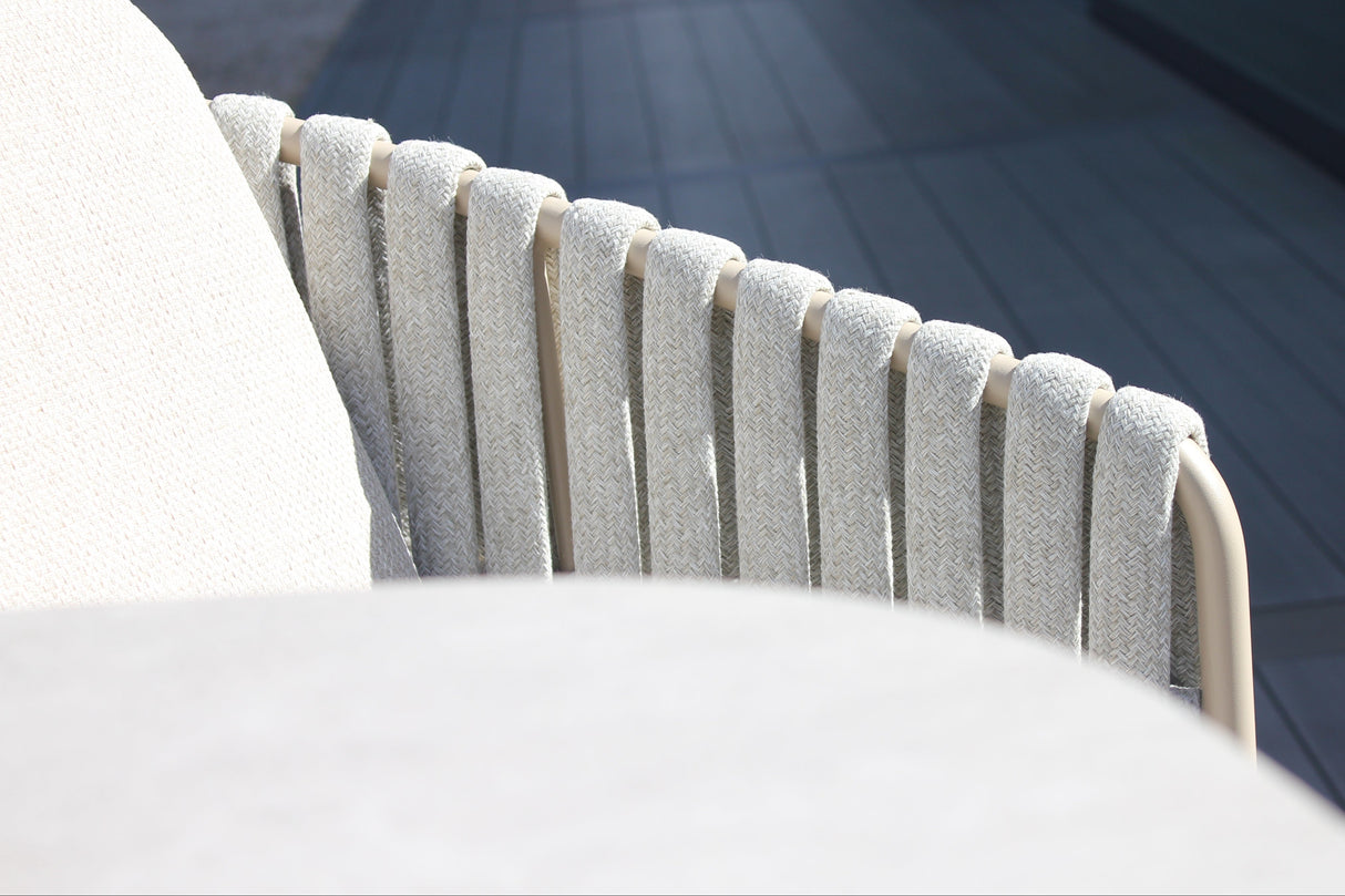 4 Seasons Outdoor Eva 6-seat metal dining set with Manolo 180cm barrel ceramic table and latte-colored dining chairs with cushions.