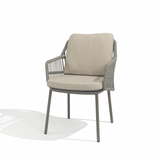 4 Seasons Outdoor Alicante dining set with Manolo 75cm round metal table and two cushioned chairs in Terre color.