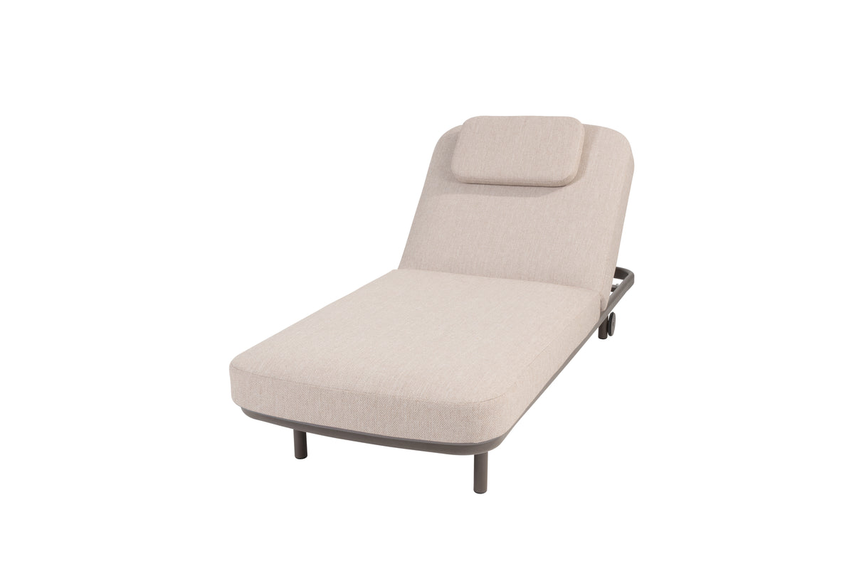 4 Seasons Outdoor Milano Terre sunbed with latte-colored metal frame, cushion, and headrest for outdoor relaxation.
