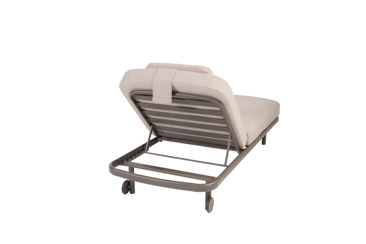 4 Seasons Outdoor Milano Terre sunbed with latte-colored metal frame, cushion, and adjustable headrest for outdoor lounging.