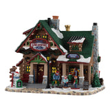 Lemax Alpine Adventures Ski School illuminated building from Christmas village display, featuring a ski school scene with lights and festive details.