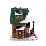 Lemax Alpine Adventures Ski School illuminated building from Christmas village display, featuring a snowy mountain scene and festive lights.