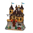 Illuminated Lemax Arie's Castle building from the Christmas Village collection, featuring festive lights and detailed holiday scene.