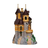 Illuminated Lemax Arie's Castle Christmas Village building with detailed castle design and festive lighting display.