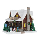 Lemax Cozy Forest Cabin illuminated Christmas village building with snowy details and festive holiday decorations.