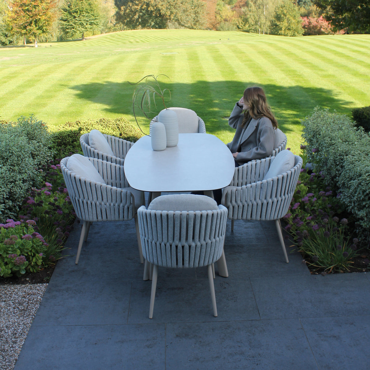 4 Seasons Outdoor Eva 6-seat metal dining set with Manolo 180cm barrel ceramic table, outdoor furniture for dining and entertaining.