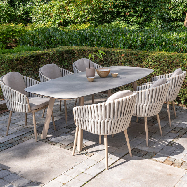 4 Seasons Outdoor Eva 6-seat metal dining set with Manolo 180cm barrel ceramic table, Latte-colored dining chairs and table.