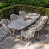 4 Seasons Outdoor Eva 6-seat metal dining set with Manolo 180cm barrel-shaped ceramic table, Latte-colored dining chairs.