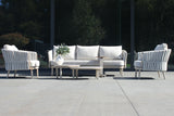 4 Seasons Outdoor Eva lounge set with two Monroe coffee tables and a gentle support table, featuring metal frame and comfortable cushions.