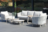 4 Seasons Outdoor Eva lounge set with two Monroe coffee tables and a gentle support table, featuring metal furniture in a latte finish.