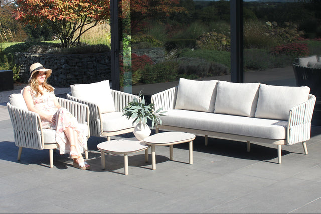 4 Seasons Outdoor Eva lounge set with two Monroe coffee tables in latte finish, featuring metal construction and comfortable seating.
